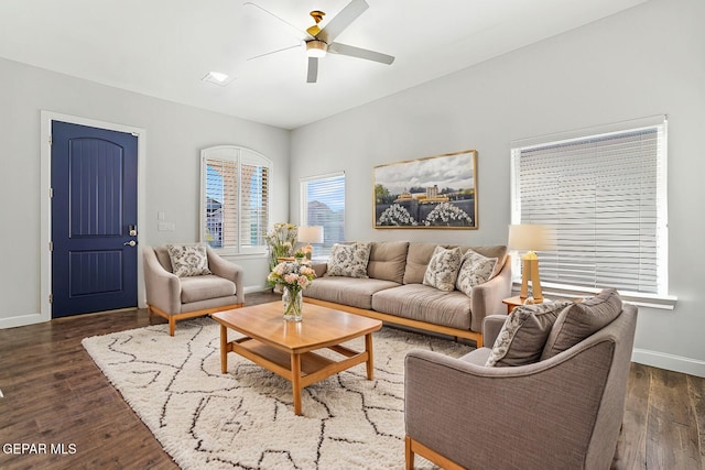 living room featuring ceiling fan and dark hardwood / wood-style floors