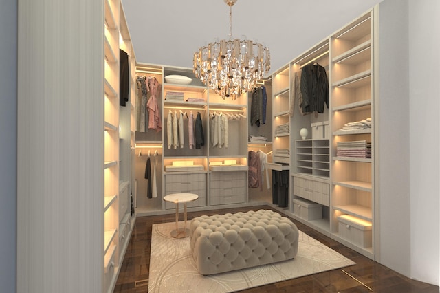 walk in closet with dark hardwood / wood-style floors and an inviting chandelier