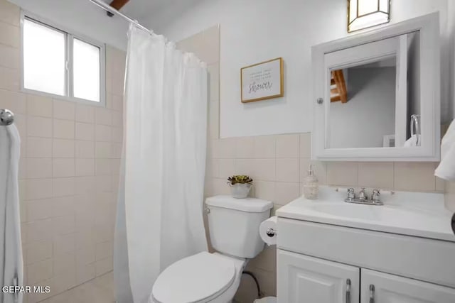 bathroom with toilet, vanity, tile walls, decorative backsplash, and a shower with curtain