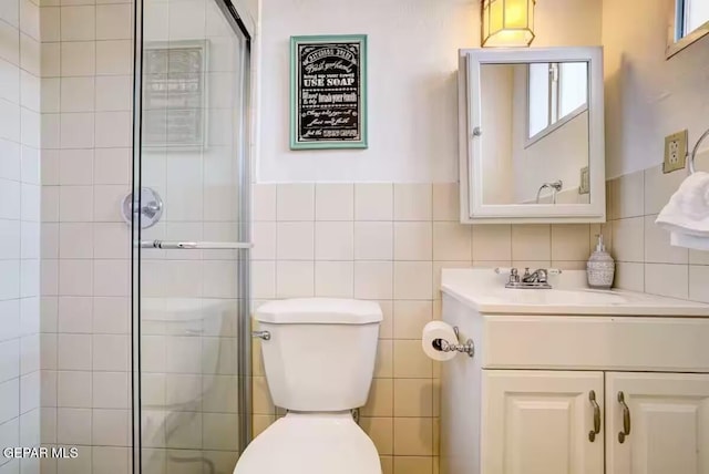 bathroom with toilet, vanity, and plenty of natural light