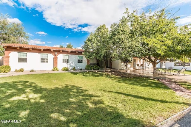 view of front of house featuring a front yard and a patio