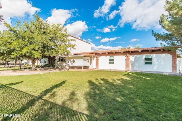 back of house with a lawn