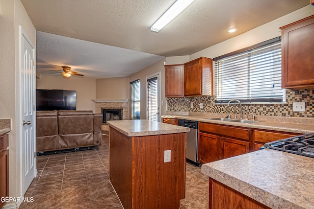 kitchen featuring tasteful backsplash, dishwasher, a center island, and sink