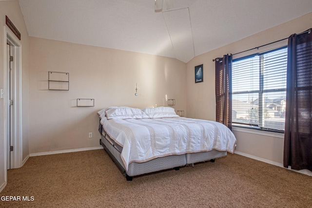 carpeted bedroom with lofted ceiling