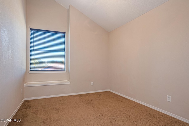 unfurnished room with carpet and vaulted ceiling