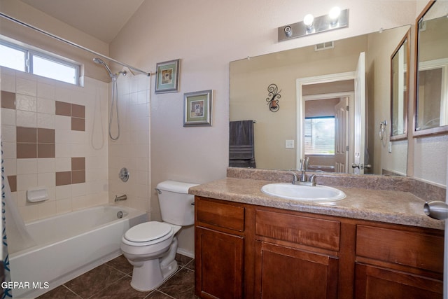 full bathroom featuring vanity, tile patterned flooring, toilet, tiled shower / bath, and lofted ceiling