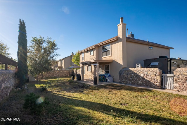 rear view of house with a lawn