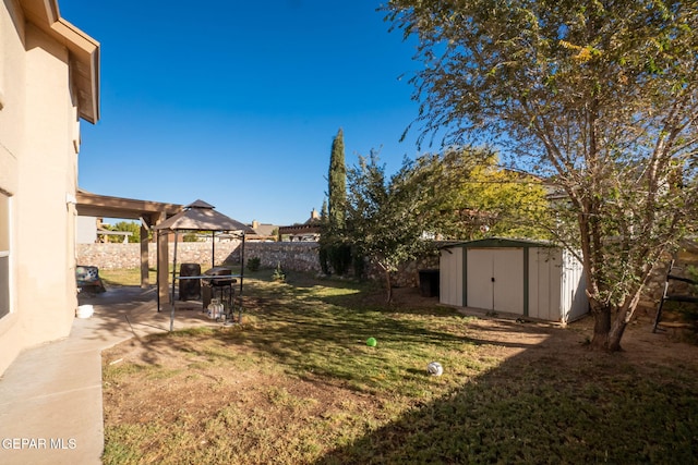 view of yard with a gazebo and a storage shed