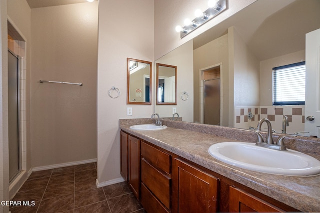 bathroom featuring tile patterned flooring, vanity, and a shower with shower door