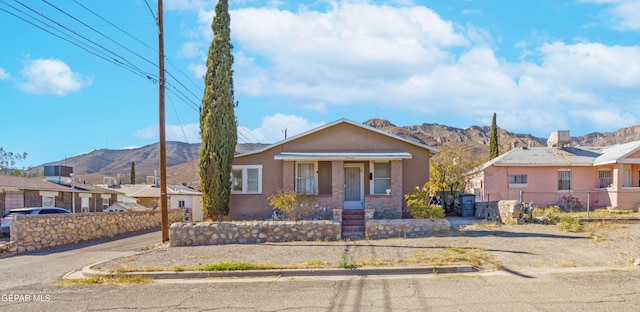 view of front facade featuring a mountain view and a porch