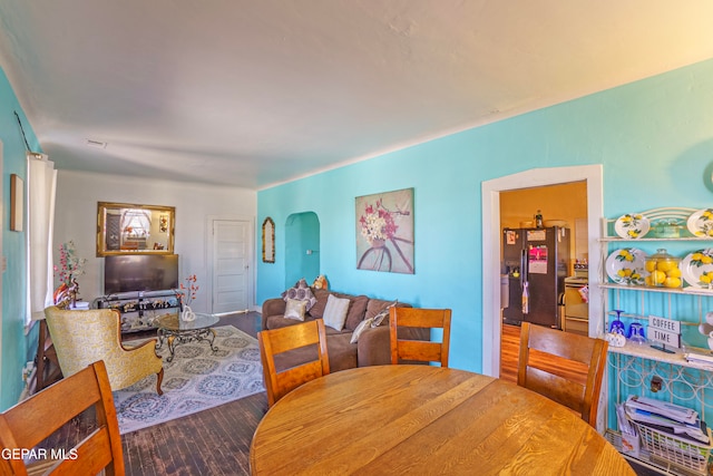 dining space with wood-type flooring