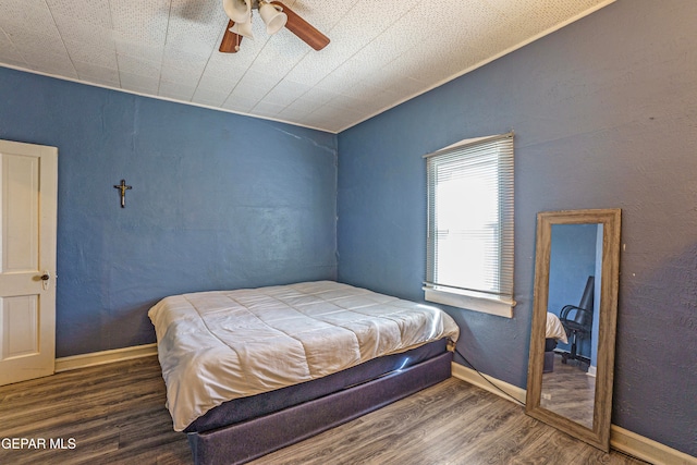 bedroom with ceiling fan and dark hardwood / wood-style floors