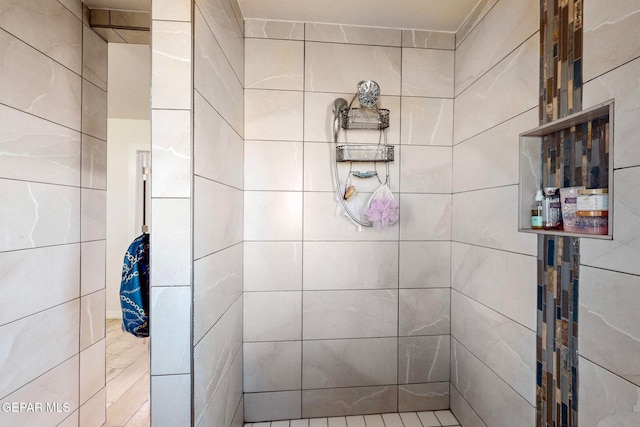 bathroom with a tile shower