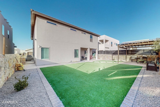 rear view of property featuring a pergola, a patio area, and a yard