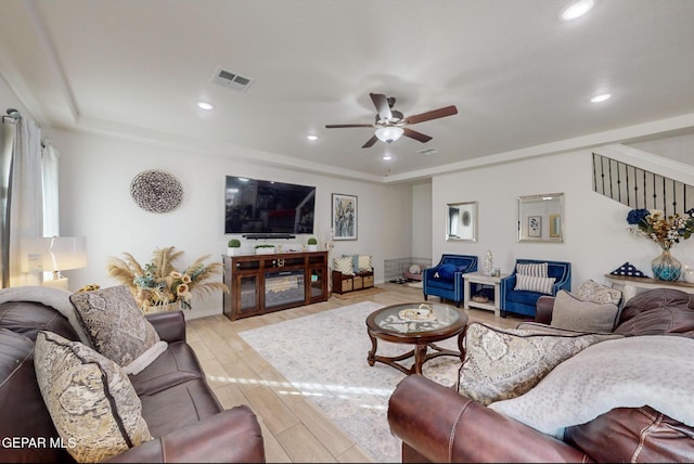 living room featuring ceiling fan and light hardwood / wood-style floors