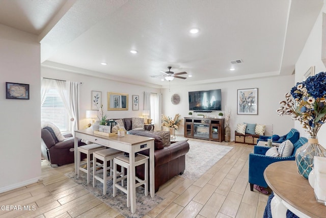 living room featuring light hardwood / wood-style floors and ceiling fan