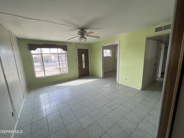 tiled empty room with ceiling fan