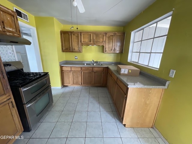 kitchen featuring ceiling fan, light tile patterned flooring, stainless steel range with gas cooktop, and sink