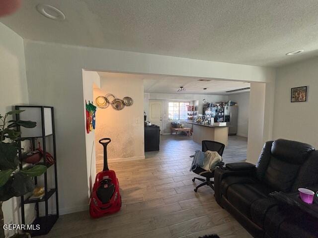 living room with hardwood / wood-style floors and a textured ceiling