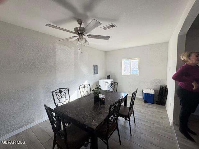 dining space with ceiling fan and hardwood / wood-style floors