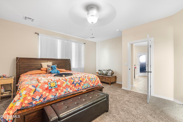 bedroom featuring light colored carpet and ceiling fan