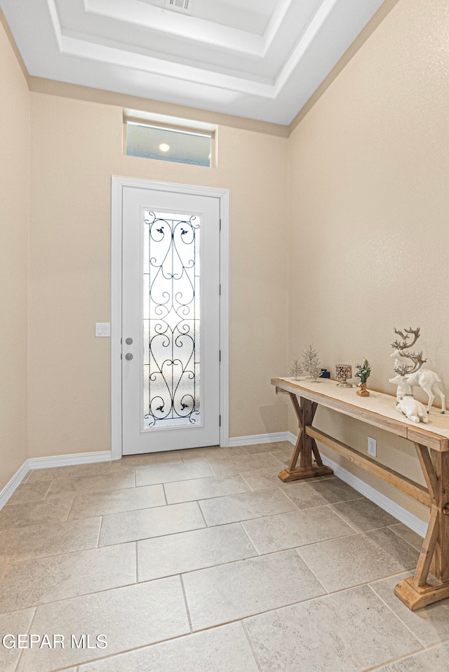 foyer with a tray ceiling