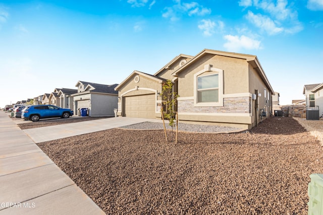 view of front of home with central air condition unit and a garage