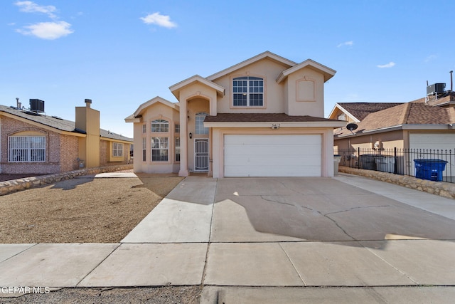 view of front property featuring central AC unit and a garage