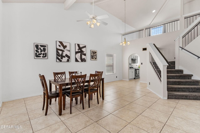 dining room with beamed ceiling, a wealth of natural light, high vaulted ceiling, and ceiling fan