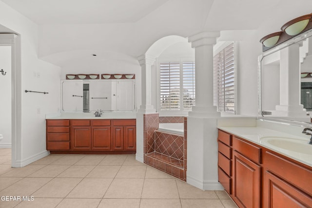 bathroom featuring vanity, tile patterned floors, and tiled tub