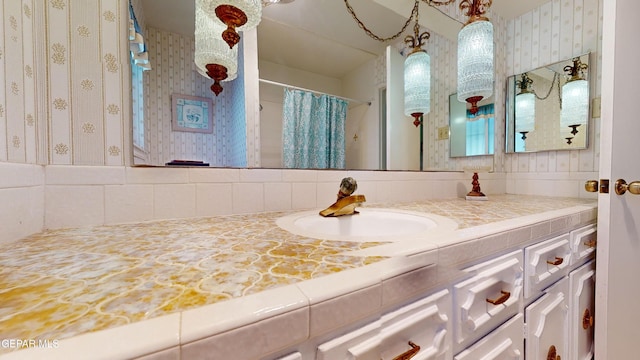 532 Satellite Dr, El Paso, TX 79912 - bathroom featuring vanity, decorative backsplash, and walk in shower