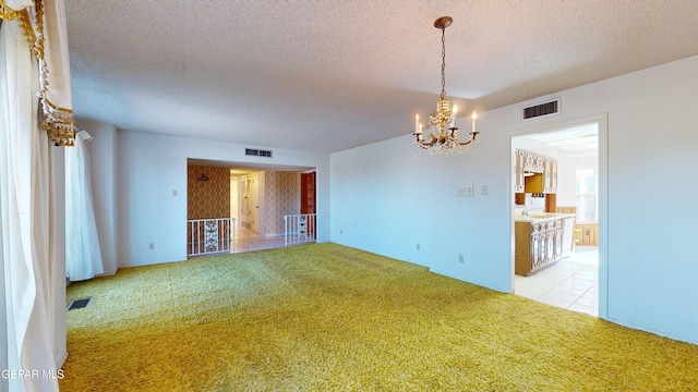 532 Satellite Dr, El Paso, TX 79912 - spare room with a chandelier, sink, light colored carpet, and a textured ceiling