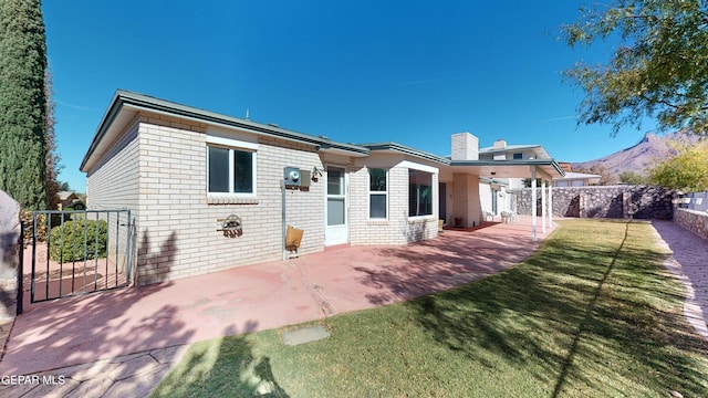 532 Satellite Dr, El Paso, TX 79912 - rear view of house with a mountain view, a yard, and a patio