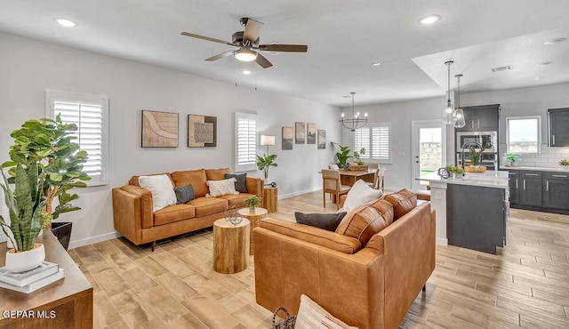 900 Stoke St, El Paso, TX 79928 - living area featuring light wood finished floors, ceiling fan, baseboards, recessed lighting, and a chandelier