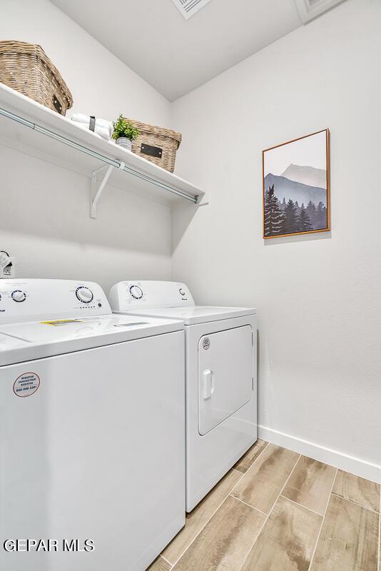 900 Stoke St, El Paso, TX 79928 - laundry room with separate washer and dryer, wood tiled floors, and baseboards