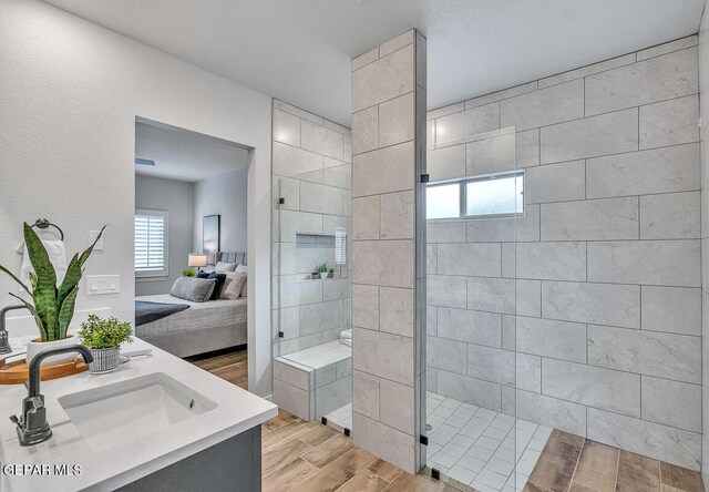 900 Stoke St, El Paso, TX 79928 - ensuite bathroom with vanity, walk in shower, and wood finished floors
