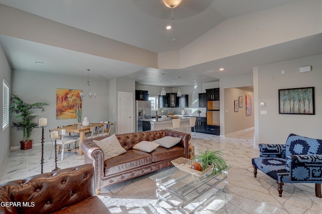 living area featuring baseboards, marble finish floor, vaulted ceiling, a chandelier, and recessed lighting