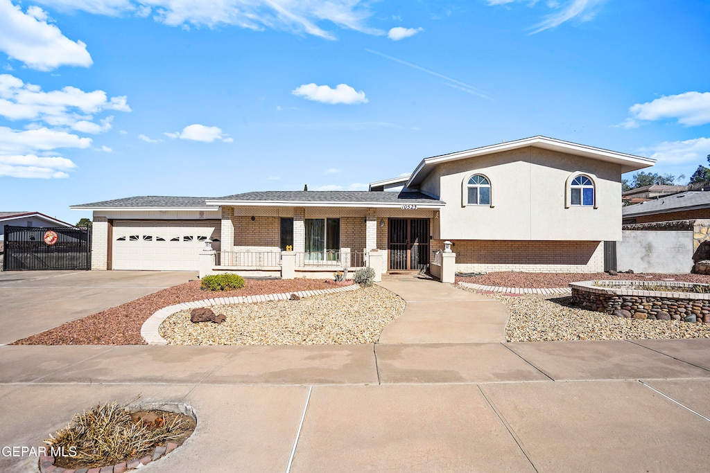 view of front of home featuring a porch and a garage