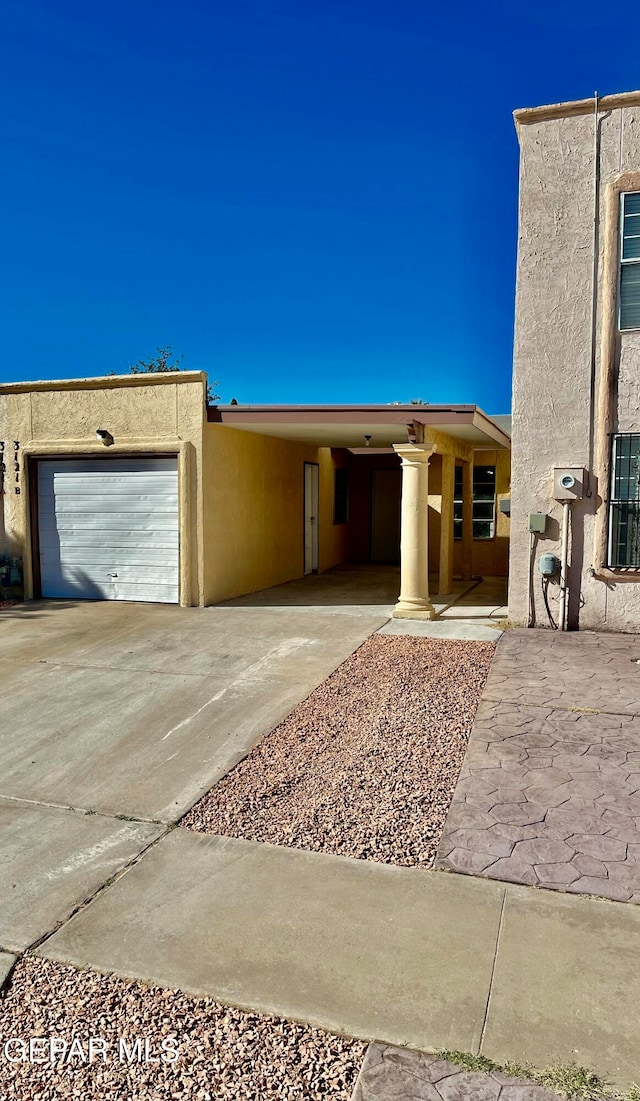 view of front of house with a garage and a carport