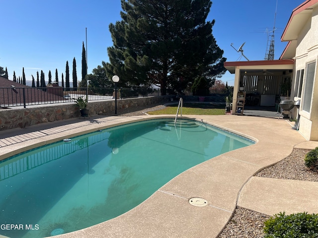 view of swimming pool featuring area for grilling and a patio