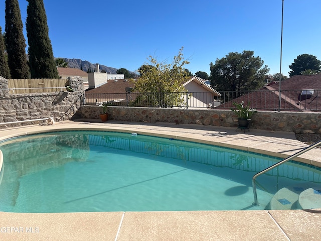 view of swimming pool with a mountain view