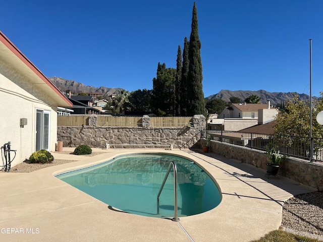 view of swimming pool featuring a mountain view and a patio area