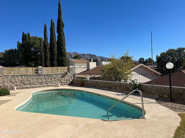 view of pool with a mountain view and a patio area