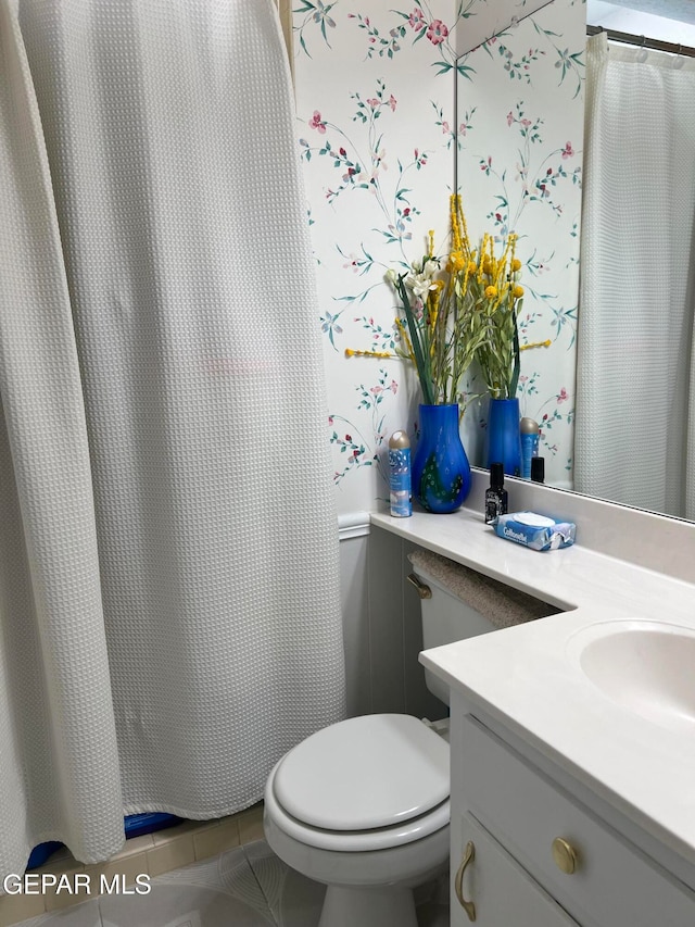 bathroom with vanity, tile patterned floors, and toilet