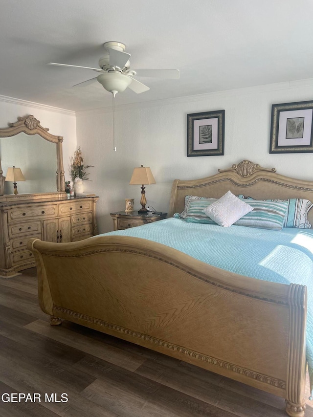 bedroom featuring ornamental molding, dark hardwood / wood-style floors, and ceiling fan