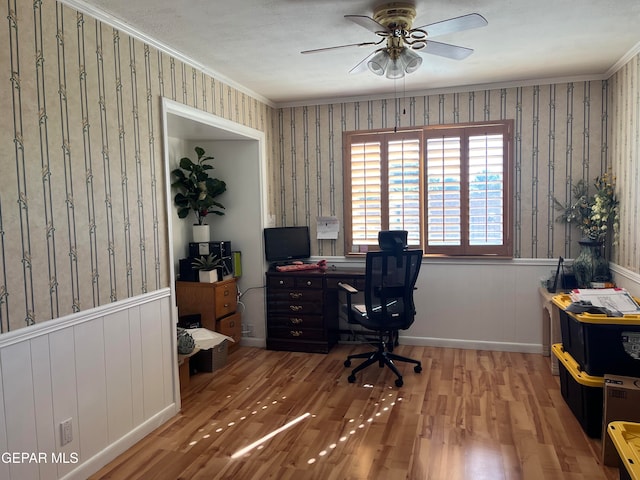 home office featuring hardwood / wood-style flooring, ceiling fan, and crown molding