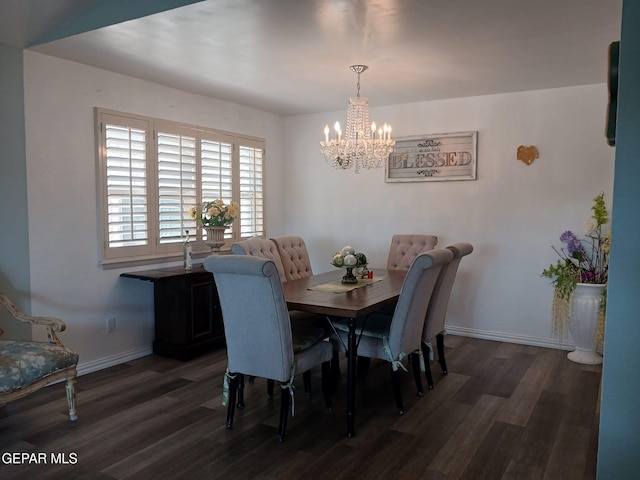 dining space featuring dark wood-type flooring and an inviting chandelier