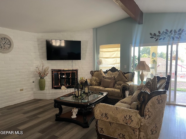 living room with a fireplace, lofted ceiling with beams, wood-type flooring, and brick wall