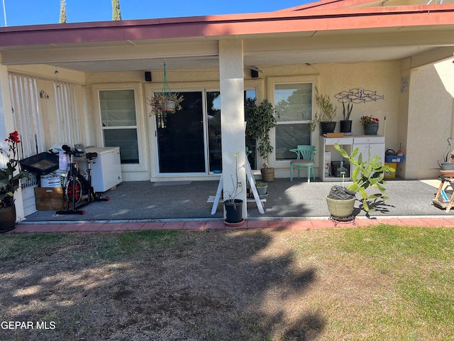 entrance to property featuring a patio area