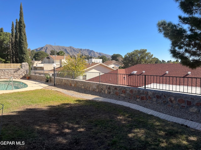 view of yard featuring a mountain view and a fenced in pool